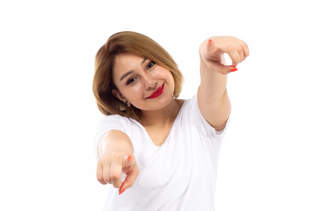 A front view young lady in white t-shirt posing smiling happy on the white