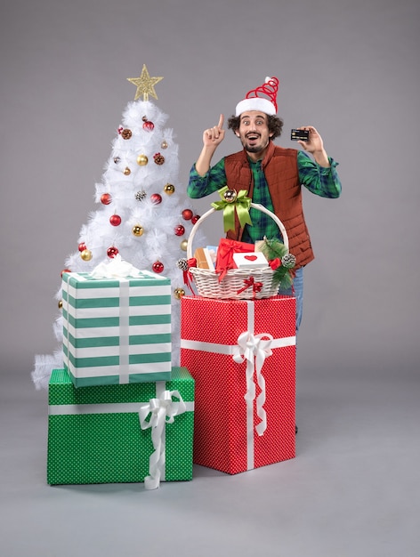 Free photo front view young male around holiday presents on the grey