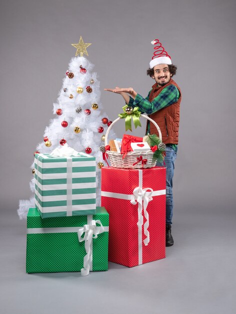 Front view young male around holiday presents on light 