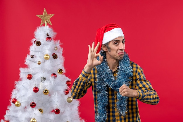 Front view young male around new year atmosphere on red wall color christmas holiday