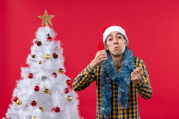 Front view young male around new year atmosphere on a red wall color christmas holidays