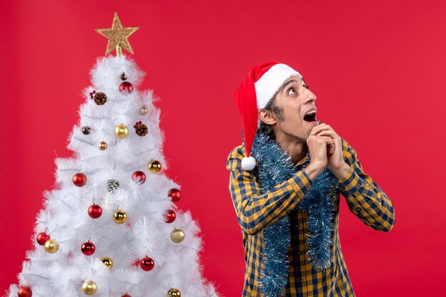 Front view young male around new year atmosphere on a red wall emotion holiday christmas