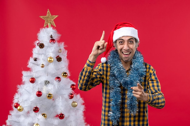 Front view young male around new year atmosphere on red wall holiday christmas human