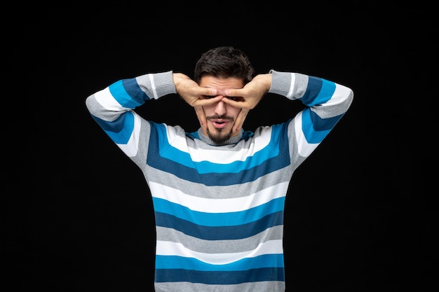 Free photo front view young male in blue striped jersey on the black wall