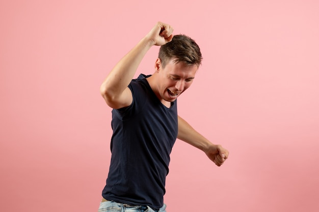 Free photo front view young male in blue t-shirt rejoicing on pink background man model emotion color male