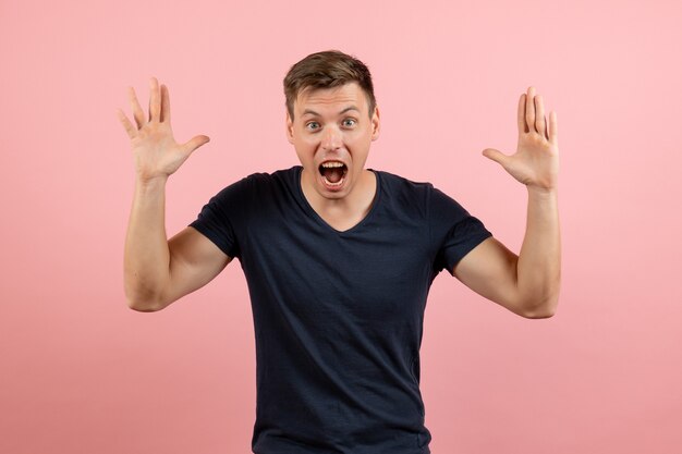 Front view young male in blue t-shirt screaming on pink background male emotion color model human