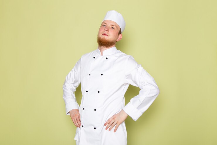 Free Photo a front view young male cook in white cook suit white head cap posing