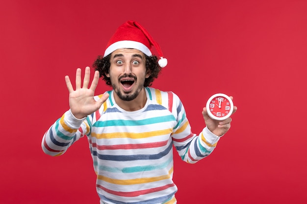 Front view young male counting showing number on red wall red time new year holiday