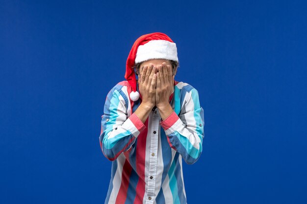 Front view young male covering his face, christmas emotion male