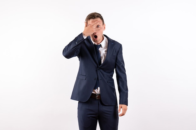 Front view young male covering his face in classic strict suit on white background fashion emotions human model suit male
