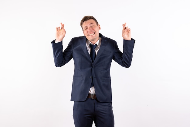 Free photo front view young male crossing his fingers in classic strict suit on white background emotions human fashion model suit male