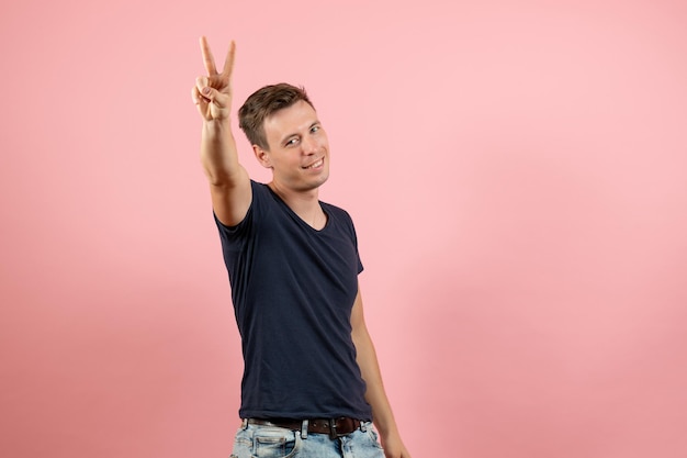 Free photo front view young male in dark-blue shirt on light pink background