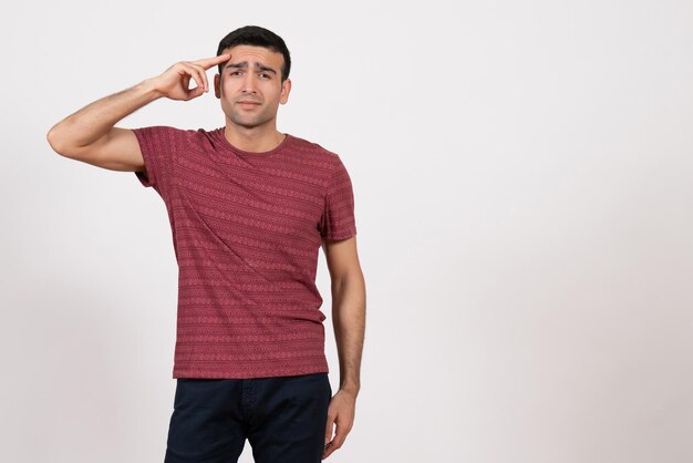 Front view young male in dark-red t-shirt posing on white background