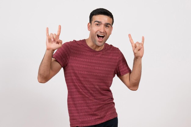 Front view young male in dark-red t-shirt posing on white background