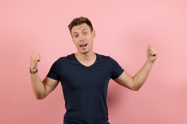 Front view young male in dark t-shirt and jeans on pink background