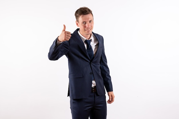 Front view young male in elegant classic suit smiling and posing on white background