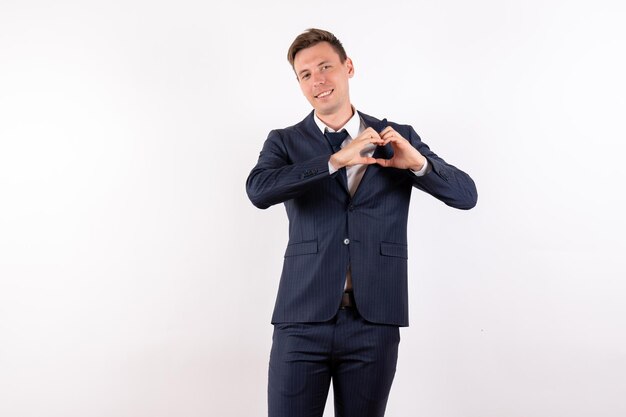 Front view young male in elegant classic suit smiling on white background