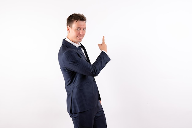 Front view young male in elegant classic suit smiling on white background