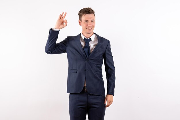 Front view young male in elegant classic suit smiling on white background