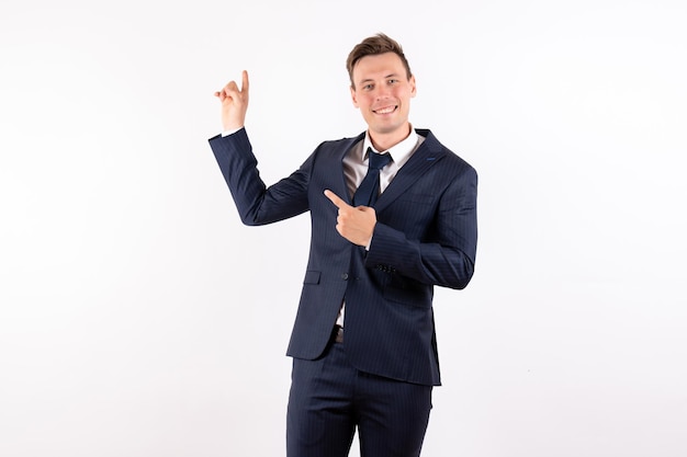 Front view young male in elegant classic suit smiling on white background