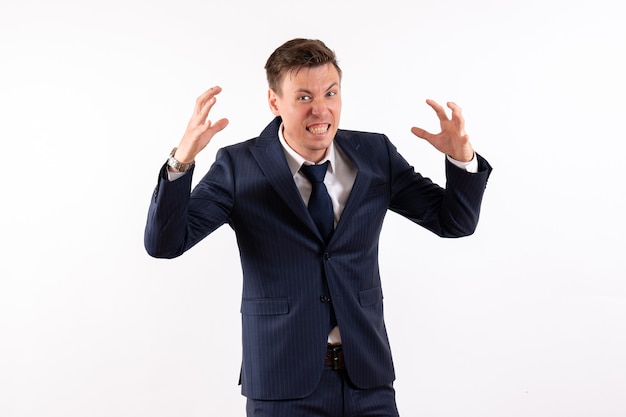 Front view young male emotionally posing in classic suit on white background emotion color model human male