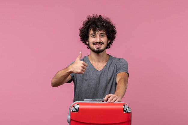 Front view young male getting ready for vacation smiling on pink space