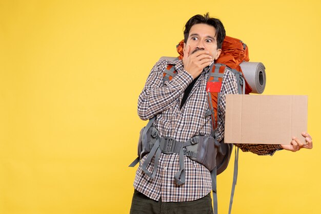 Front view young male going in hiking with backpack on yellow background color air nature company forest trip campus