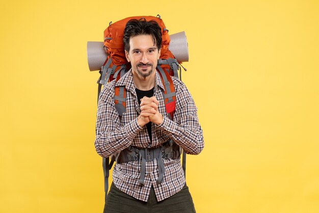 Front view young male going in hiking with backpack on a yellow background color tourist mountain human height campus