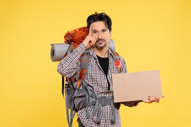 Front view young male going in hiking with backpack on a yellow background map color air nature company forest trip campus