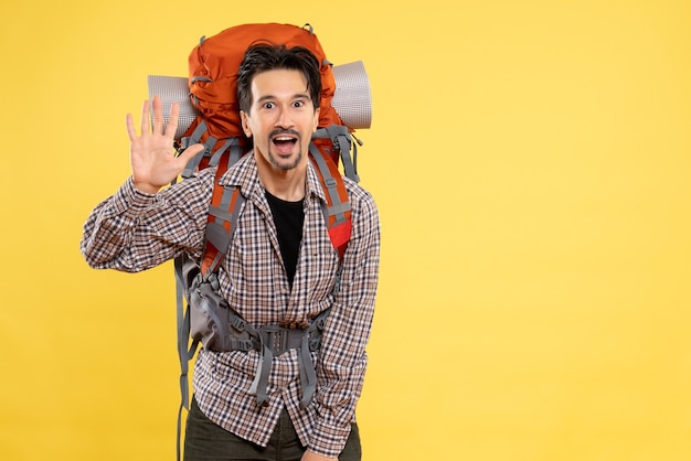 Front view young male going in hiking with backpack on the yellow background tourist mountain human color height campus