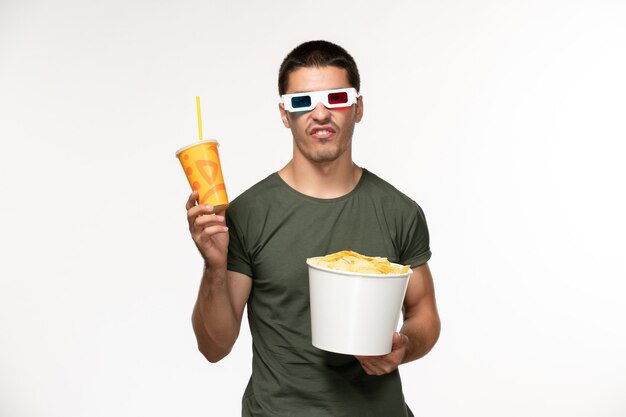 Front view young male in green t-shirt holding potato cips soda in d sunglasses on a white wall film male lonely movies cinema