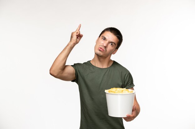 Front view young male in green t-shirt with potato cips on white wall person lonely film movie cinema