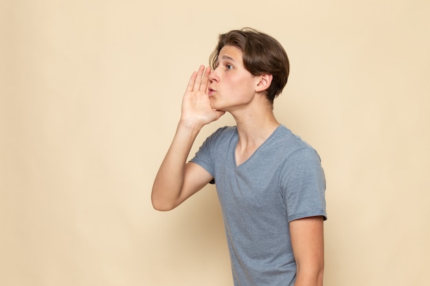 A front view young male in grey t-shirt calling out