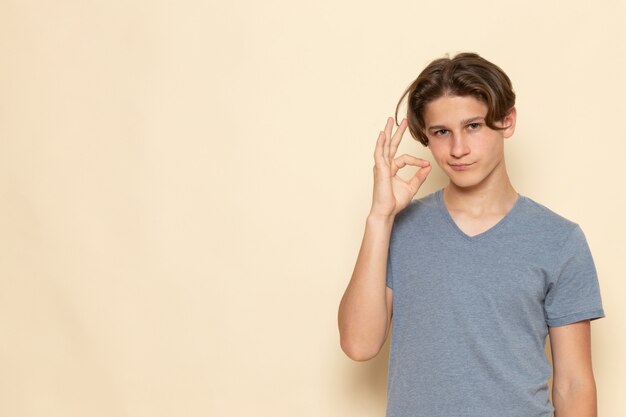 A front view young male in grey t-shirt posing