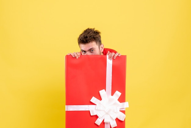 Free photo front view young male hiding inside present box