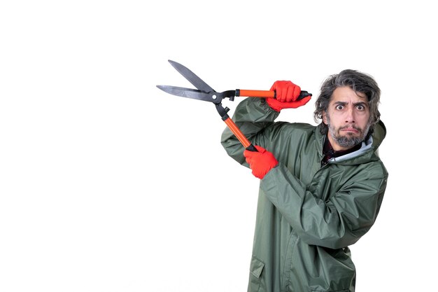 Front view young male holding garden secateurs on white background plant flowers job emotion tree grass soil work gardener