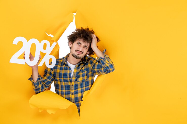 Free Photo front view young male holding writing on yellow background