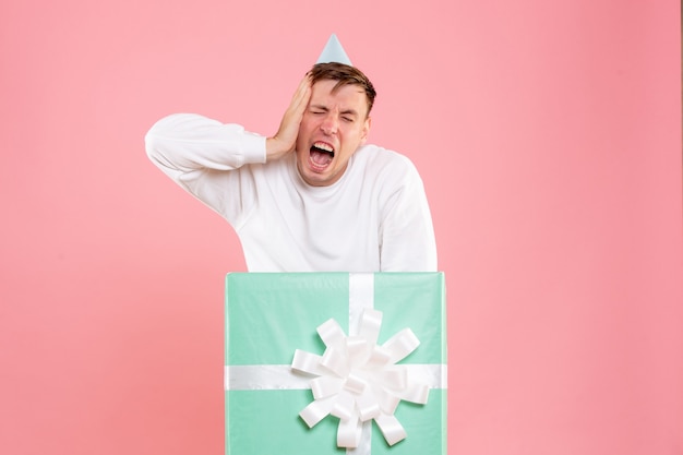 Free photo front view young male inside present on pink background