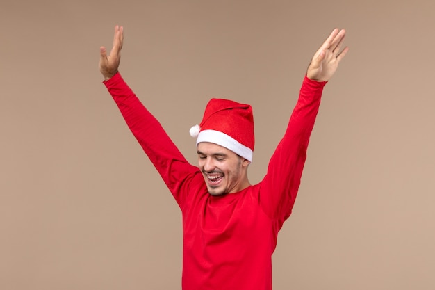 Free photo front view young male just dancing on brown background christmas emotion holiday