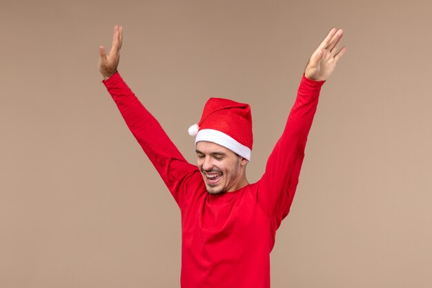 Front view young male just dancing on brown background christmas emotion holiday