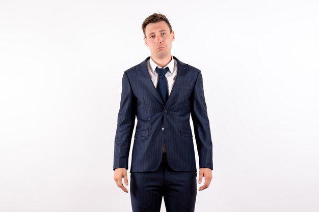Front view young male just standing in classic strict suit on white background