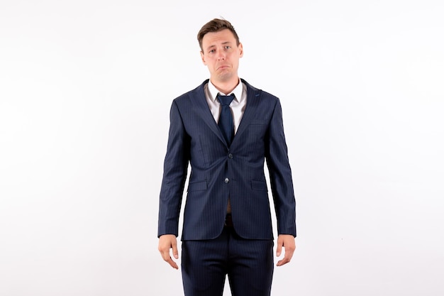 Front view young male just standing in classic strict suit on white background