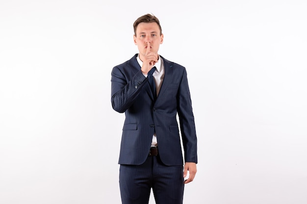 Front view young male posing in classic strict suit on a light white background