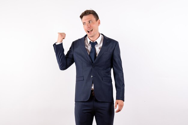 Front view young male posing in classic strict suit on light white background