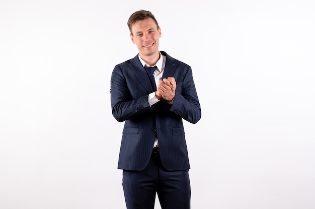 Front view young male posing in classic strict suit smiling on white background