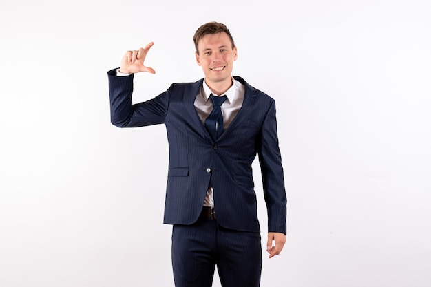 Front view young male posing in classic strict suit on white background