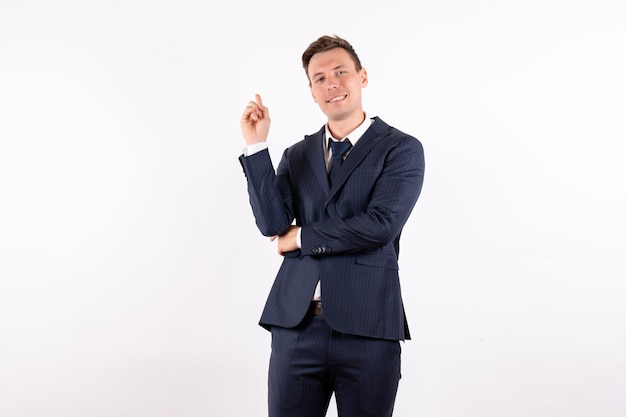 Front view young male posing in classic strict suit on white background