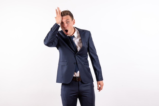 Front view young male posing in classic strict suit on white background