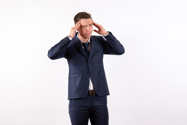 Front view young male posing in classic strict suit on white background