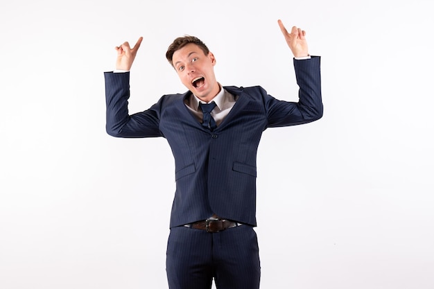 Front view young male posing in classic strict suit on white background